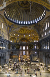 Turkey, Istanbul, Sultanahmet Haghia Sophia Sightseeing tourists beneath the dome with murals and