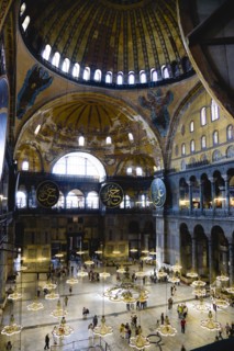 Turkey, Istanbul, Sultanahmet Haghia Sophia Sightseeing tourists beneath the dome with murals and