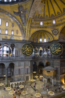 Turkey, Istanbul, Sultanahmet Haghia Sophia Sightseeing tourists beneath the dome with murals and