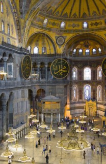 Turkey, Istanbul, Sultanahmet Haghia Sophia Sightseeing tourists beneath the dome with murals and