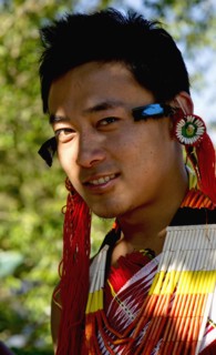 PORTRAIT OF A TRIBAL FROM A NAGA WARRIOR TRIBE WEARING TRADITIONAL COSTUME AND JEWELRY, NAGALAND, NORTH EAST INDIA
