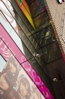Japan, Honshu, Tokyo, Ginza district reflection of busy traffic scene in glass fronted building.