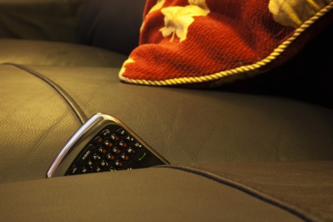 Communications, Telephones, Mobile, Phone stuck between cushions of leather sofa. 
Photo : Stephen