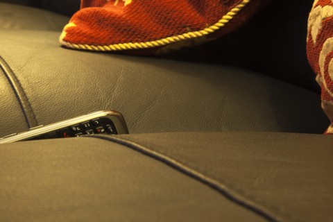Communications, Telephones, Mobile, Phone stuck between cushions of leather sofa. 
Photo : Stephen
