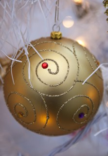 Festivals, Christmas, Decorations gold coloured bauble with white tinsel and fairy lights. 
Photo
