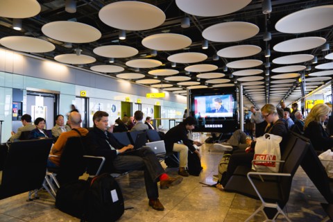 England, London, Heathrow Airport Terminal 5 disc ceiling in departures zone with passengers