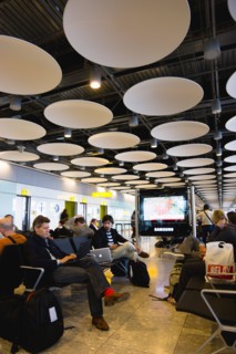 England, London, Heathrow Airport Terminal 5 disc ceiling in departures zone with passengers