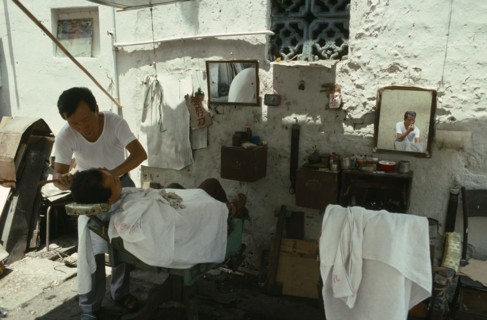 Georgetown man having a shave from a street barber.