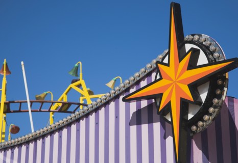 Facade of amusement arcade in clear blue sky.