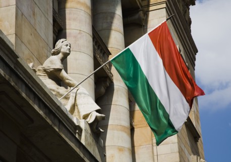 Hungarian Flag flying with Art Nouveau facade behind in central Pest.