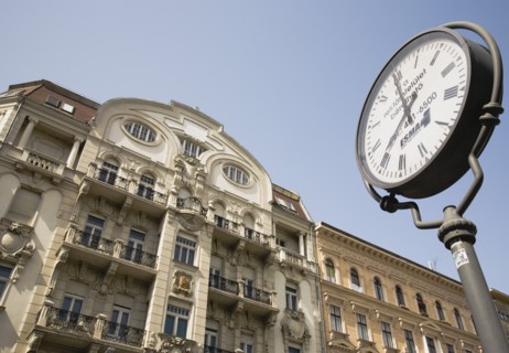 Clock with Art Nouveau facade behind in central Pest.