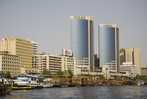 Creek with Twin Towers shopping mall and skyline behind.