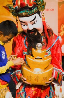Imperial Chinese performer colecting donations for Chinese New Year.