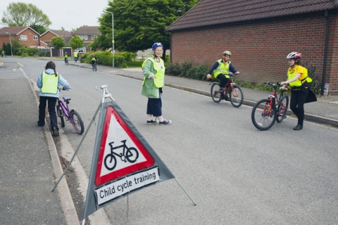 School children being taught cycle safety lessons on public roads.