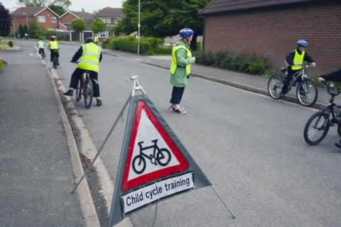 School children being taught cycle safety lessons on public roads.