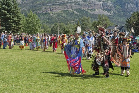 Grand Entry of dancers in full regalia at the Blackfoot Arts & Heritage Festival Pow Wow organized by Parks Canada and the Blackfoot Canadian Cultural Society at this UNESCO World Heritage Site Mount ...