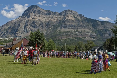 Pow Wow Grand Entry at the Blackfoot Arts & Heritage Festival to celebrate Parks Canada's centennial Flags of Canada and the United States