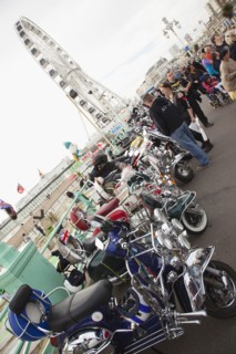 Elaborately decorated Mopeds on Madeira Drive during motorbike festival.