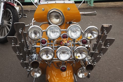 Elaborately decorated Mopeds on Madeira Drive during motorbike festival.