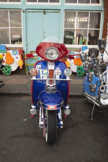 Elaborately decorated Mopeds on Madeira Drive during motorbike festival.