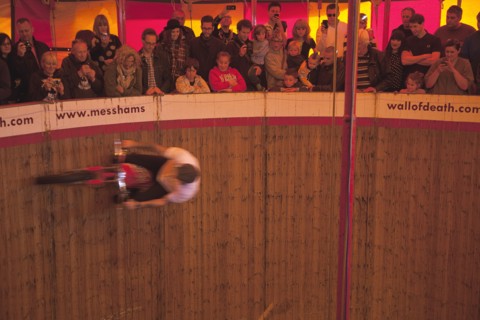 Wall of death motorcycle fairground attraction on Madeira Drive during motorbike festival.