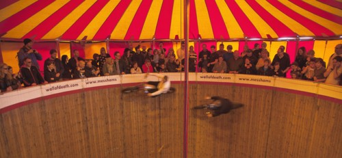 Wall of death motorcycle fairground attraction on Madeira Drive during motorbike festival.