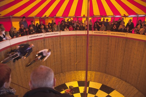 Wall of death motorcycle fairground attraction on Madeira Drive during motorbike festival.
