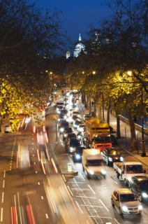 Rush hour traffic along the Embankment with St Paul's Cathedral in the background.