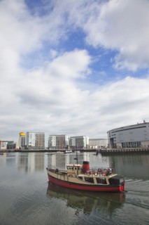 Titanic Quarter tour boat taking tourists on sightseeing cruise.