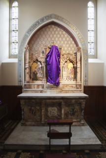Falls Road Clonard Monastery interior decorated for Good Friday with statues draped in purple cloth.