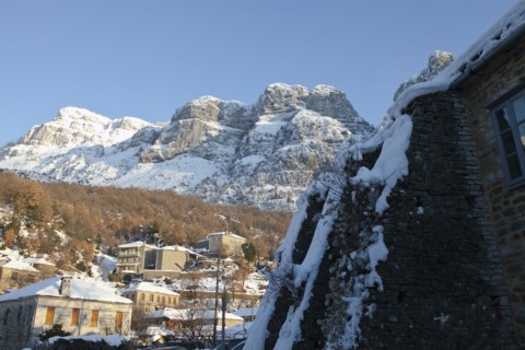View of the small traditional Greek village Mikro Papigko or Little Papigko built underneath the mountain.
