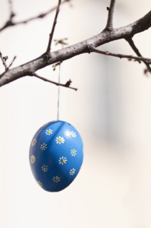 Hand-painted egg shell hanging from a branch to celebrate Easter at the Old Vienna Easter Market at the Freyung.