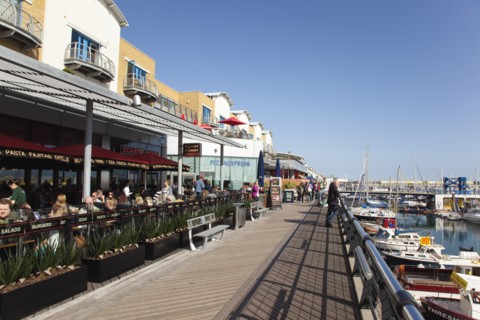View along the boardwalk over boats moored in the Marina.