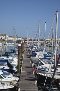 View over boats moored in the Marina with apartment buildings behind.