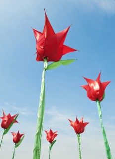 Sculture Plastic Tulips against a blue sky.