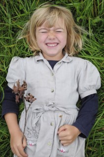 5 year old Eva lying in the grass.