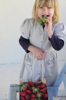 5 year old Eva eating first strawberries of the year in February.