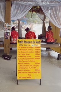 Thailand, Koh Samui , Chaweng Beach, Beach Massage with three women wearing red sat on benches