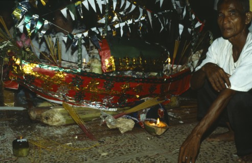 Cambodia, General, Acar or shaman with ritual model boat.Cambodia Shaman or Acar with ritual model