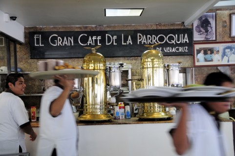 Mexico, Veracruz, Cafe El Gran Cafe de la Parroquia interior with waiters carrying laden trays past
