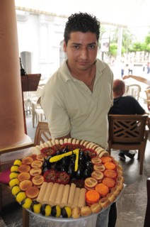 Mexico, Veracruz, Sweet seller in the Zocalo displaying large plate with variety of sweets. Photo :