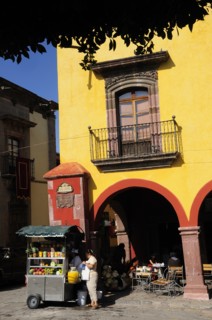 Mexico, Bajio, San Miguel de Allende, El Jardin Part view of yellow painted facade of colonial