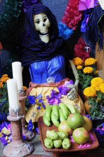 Mexico, Michoacan, Patzcuaro, Dia de los Muertos Day of the Dead altar with figures food candles