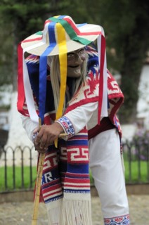 Mexico, Michoacan, Patzcuaro, Figure wearing mask and costume performing Danza de los Viejitos or