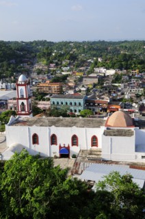 Mexico, Veracruz, Papantla, Views over Cathedral Zocalo and surrounding buildings set amongst trees