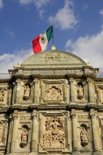 Mexico, Oaxaca, Cathedral facade with Mexican flag flying from roof. Photo : Nick Bonetti