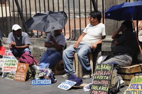 Mexico, Federal District, Mexico City, Workers plying trade outside the Cathedral in the Zocalo
