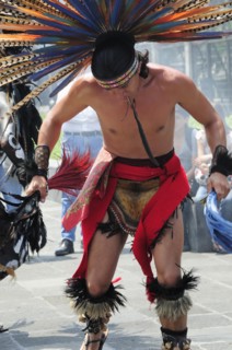 Mexico, Federal District, Mexico City, Michacoa Aztec dancer wearing brightly coloured feather