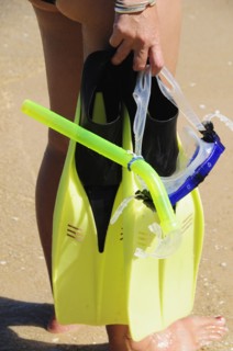 Mexico, Oaxaca, Huatulco, Playa La Entrega Cropped shot of woman snorkler carrying mask and