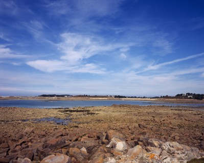 France, Cotes d Amor, Brittany, Cote de Granit Rose. Rocky shoreline with view towards Ile Grand on